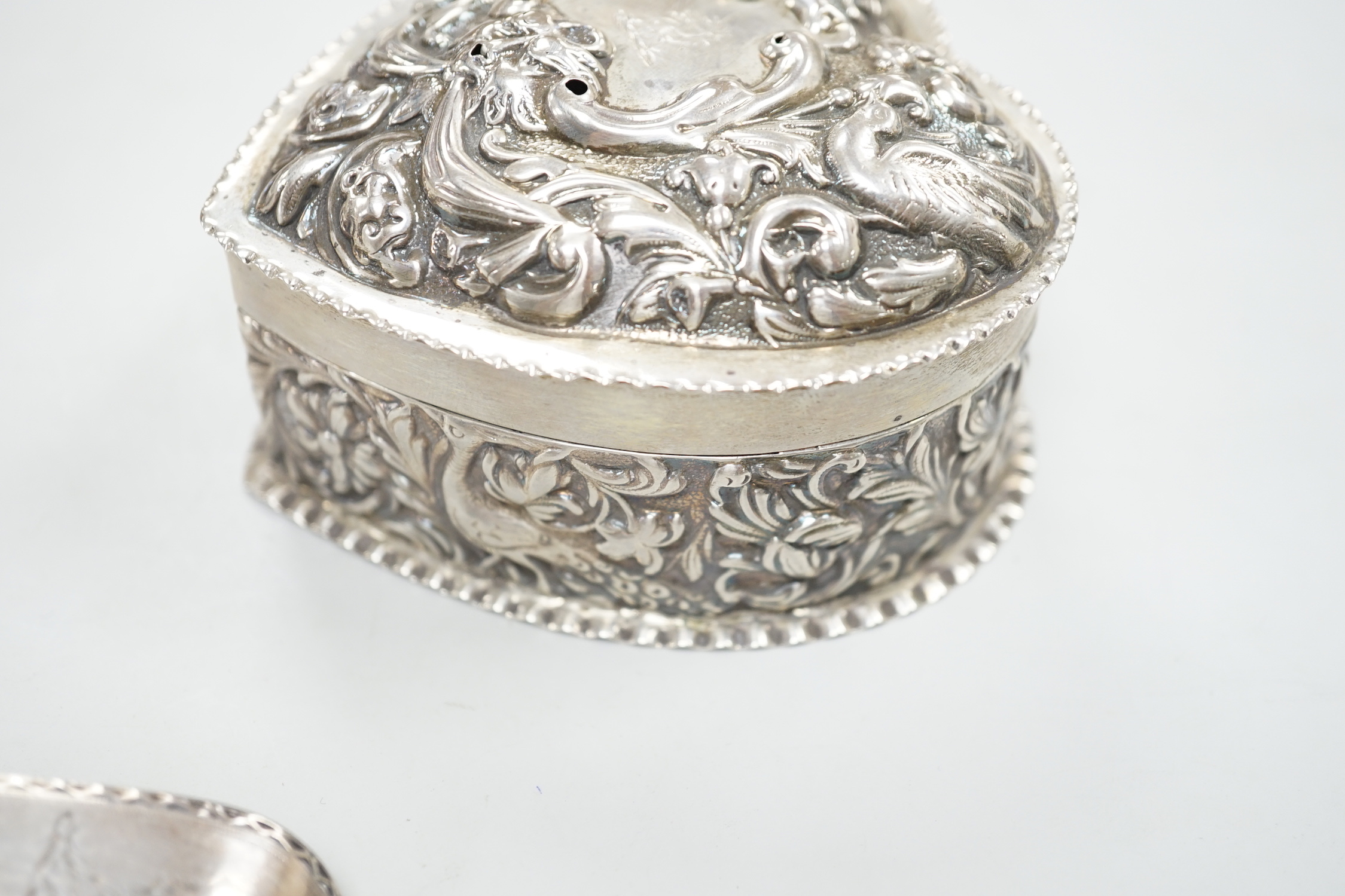 A George III silver Old English pattern bright cut engraved silver basting spoon, Sumner & Crossley, London, 1776 and a later repousse heart shaped trinket box.